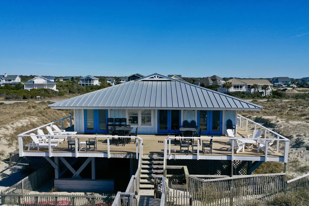 A spacious deck with comfortable seating, set against a backdrop of ocean views and open sky. The deck's unique roof design and unobstructed 270° vantage point emphasize its role as a hub for relaxation, wildlife watching, and photography, perfectly aligning with the narrative of panoramic nature immersion.
